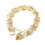 A 9ct gold gate bracelet with heart clasp and safety chain, length 16cm, approx 8.6g.
