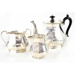 A George V hallmarked silver three-piece tea set with ebonised finial and handle and canted sides,