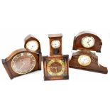 Six early/mid-20th century mantel clocks to include an oak example in the form of a longcase clock,