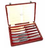 A cased set of six Queen Elizabeth hallmarked silver fruit knives retailed by Boodle & Dunthorne,