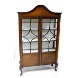 A 19th century mahogany inlaid display cabinet with dome pediment over astragal glazed doors,