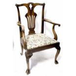 A 19th century mahogany Chippendale-style arm chair, the pierced splat back carved with scrolls,
