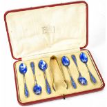 A cased set of six George V hallmarked silver coffee spoons and sugar tongs retailed by Harrods,