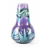 A Minton Secessionist baluster vase, purple and green ground with tube lined decoration,
