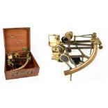 A brass sextant in a fitted wooden case with two extra lenses, maker's mark indistinct,