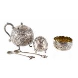 An Indian white metal three-piece cruet heavily decorated with elephants, palm trees and fish,