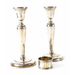 A pair of silver column candlesticks to circular spreading base, marked 'Sterling', height 18.