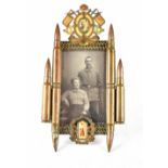 A German trench art photograph frame with photograph of the Kaiser in trophy of arms with spent