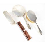 A George VI hallmarked silver backed four-piece dressing table brush and mirror set, Walker & Hall,