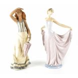 A Nao figure of a young lady with parasol and a Lladró figure of a young dancing lady,