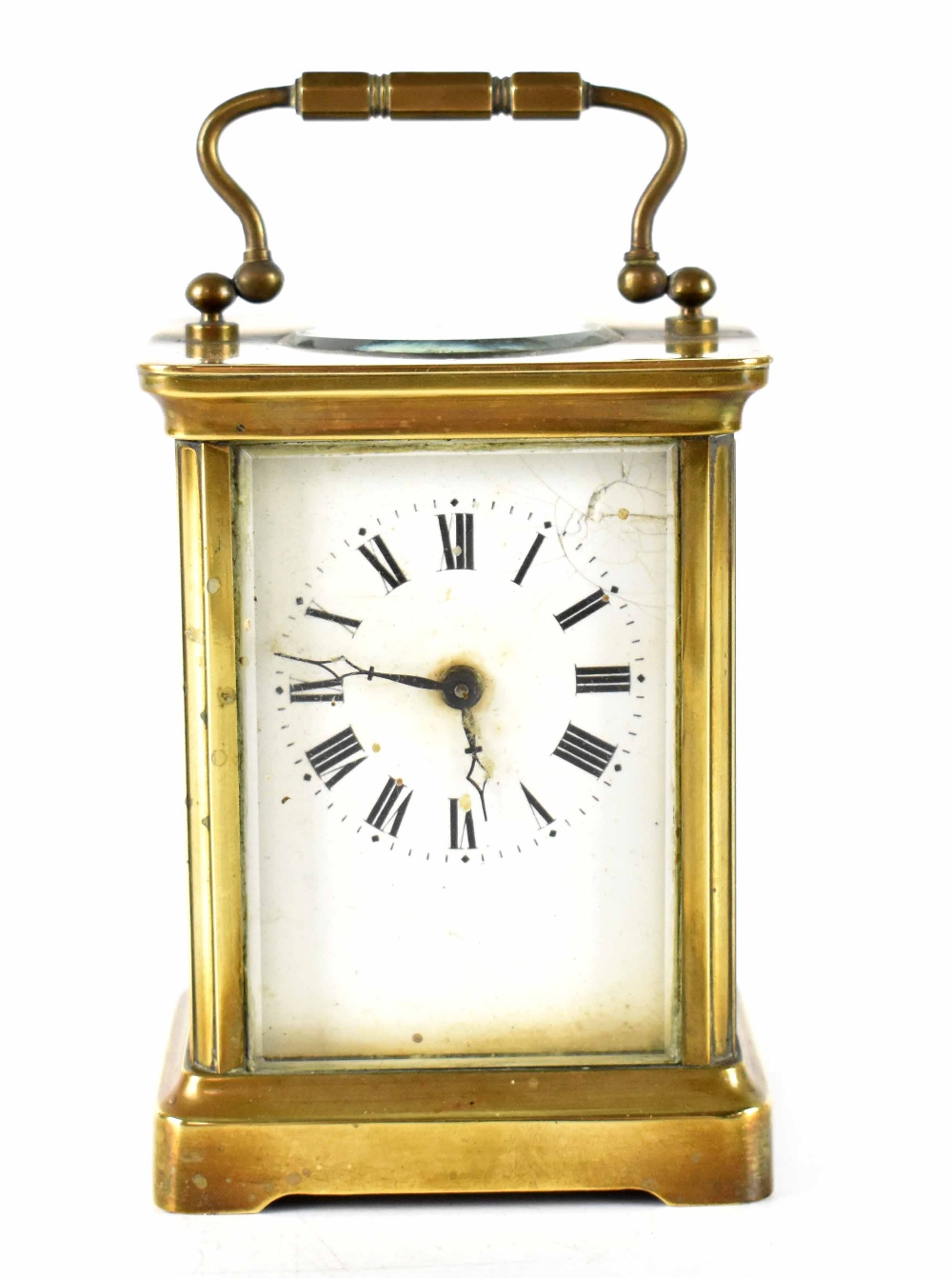 A brass-cased carriage clock, the enamelled dial set with Roman numerals, in corniche case,