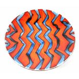 An Anita Harris charger, abstract burnt orange and denim blue design, diameter 40cm.