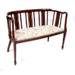 An Edwardian inlaid mahogany open two-seater settee with curved back rest,