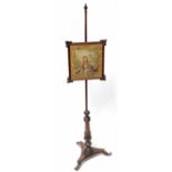 A 19th century mahogany adjustable pole screen with tapestry screen depicting lovers within a