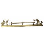 A Victorian brass fire curb/fender, scroll and bar ends, stepped base, bar and finial to the front,