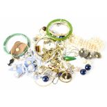 A quantity of costume jewellery to include white and yellow metal necklaces, bangles, etc.