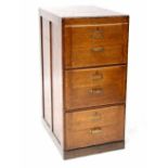 An early/mid-20th century oak three-drawer filing cabinet to plinth base, 102 x 49 x 66cm.