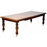A Georgian-style mahogany wind-out extending dining table with rectangular top and two extra leaves,