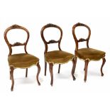 A set of eight Victorian walnut balloon-back dining chairs on cabriole legs with green velvet