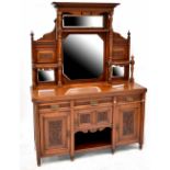 An Edwardian mahogany mirror-back sideboard, the central carved frieze above two central mirrors,