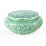A Royal Lancastrian lidded squat dressing table jar decorated in a mottled green glaze,