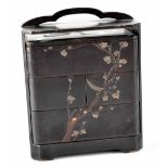 A Japanese Jubako black lacquered box decorated with birds in bamboo and blossoming branches,