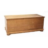 A pine blanket box on bun feet, height 48cm, length 116cm, depth 53cm.