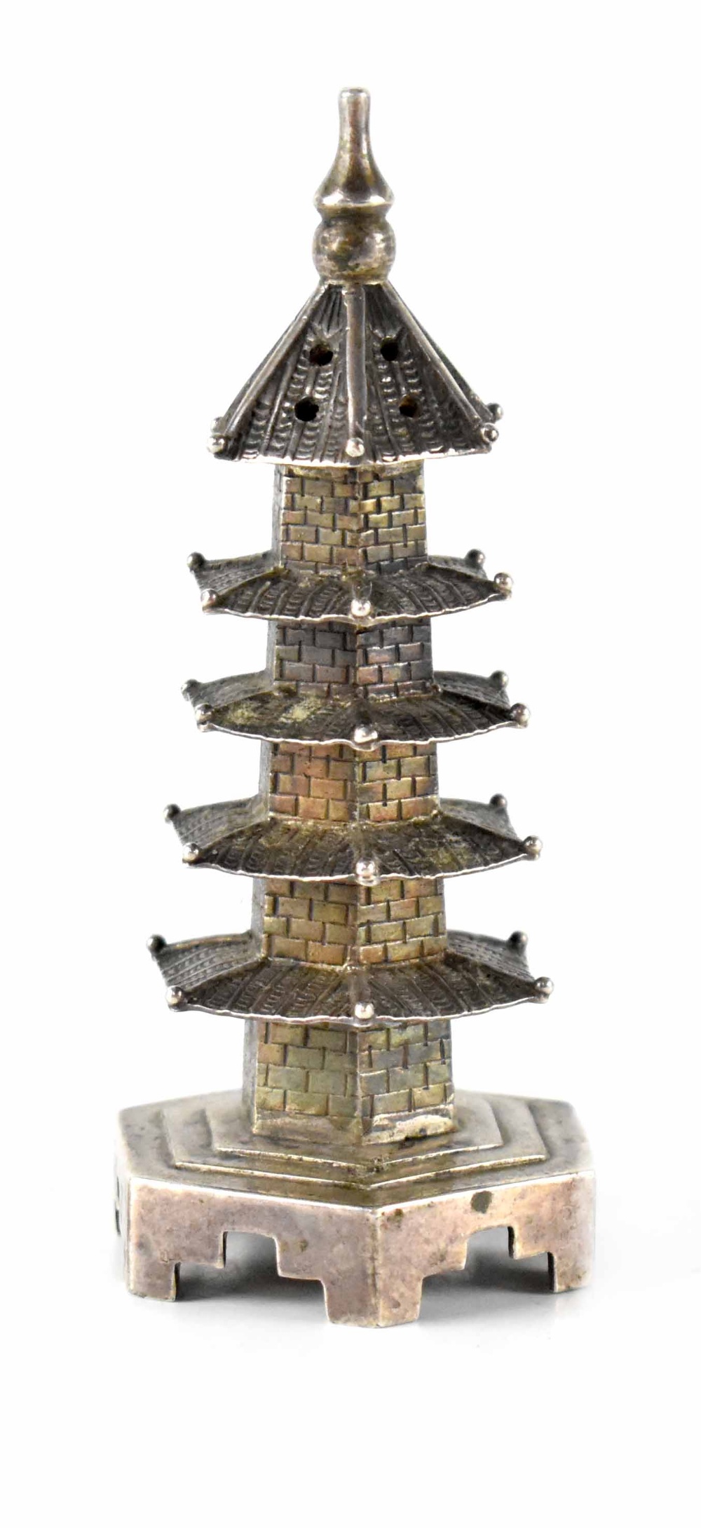 A Chinese white metal pepperette in the form of a miniature pagoda, maker's mark stamped to base,