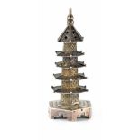 A Chinese white metal pepperette in the form of a miniature pagoda, maker's mark stamped to base,