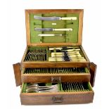 A c1921 oak-cased two-drawer twelve setting canteen of cutlery,