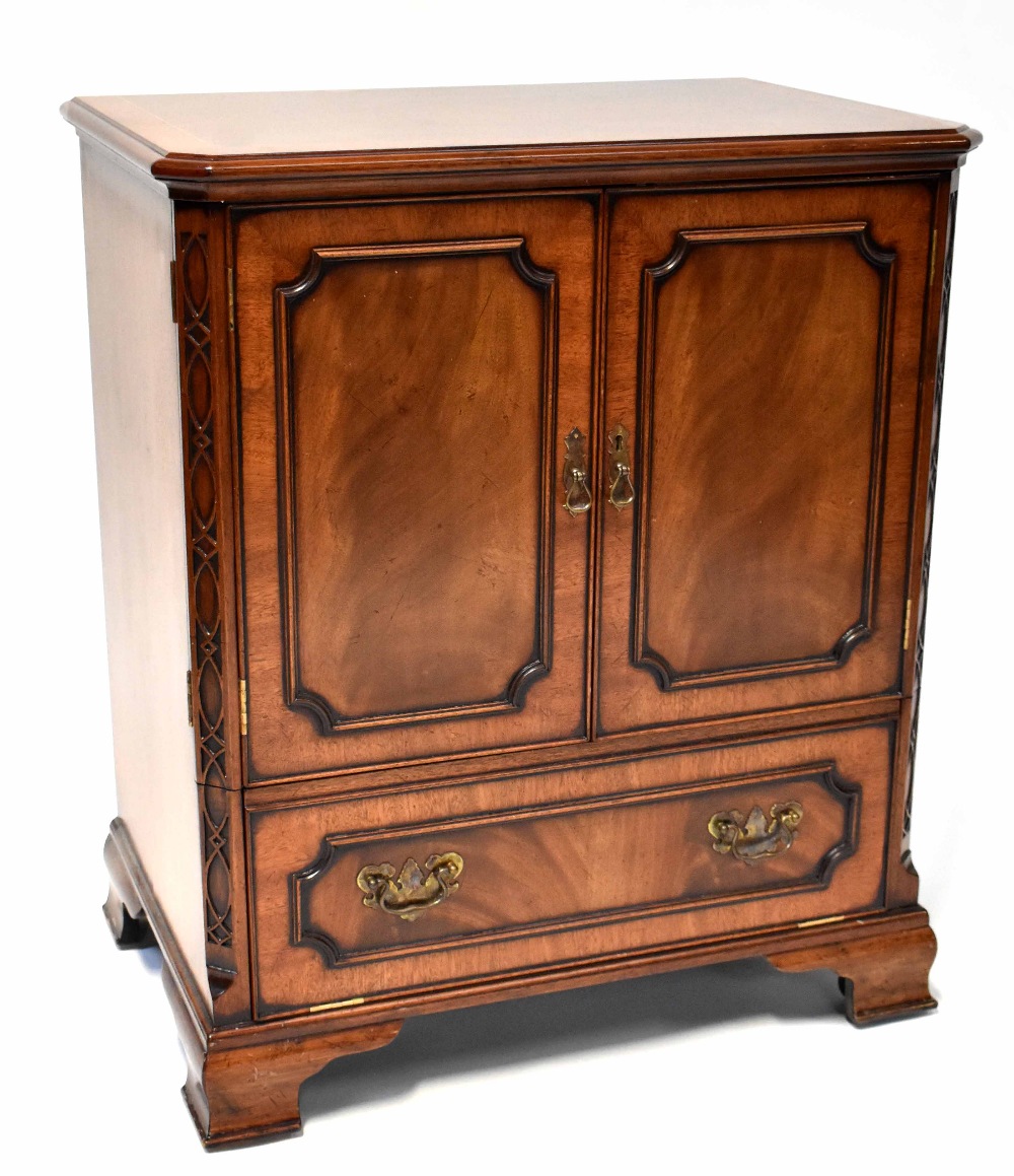 A reproduction cross-banded and line inlaid mahogany television cabinet with pair of panelled doors