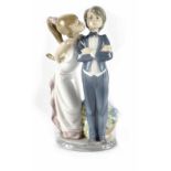 A Lladró figure group 5555 'Let's Make Up' depicting a young couple, height 21cm, with original box.