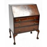 A mid-20th century mahogany bureau with fall front over three drawers, on cabriole legs,