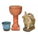 A terracotta urn on a Classical column stand and square base,