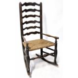 An antique blacksmith made ladder-back rocking chair,