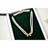 A modern bespoke made two-string pearl necklace with sapphire and diamond butterfly,