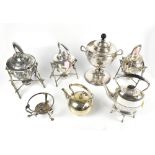 A group of silver plated items to include spirit kettles and a tea urn, some with cast and chased