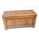 A small oak blanket box with linenfold decoration.