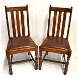 A set of six early 20th century oak splat back dining chairs with drop-in seats on bun feet (6).