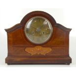 An Edwardian inlaid mahogany mantel clock, the central brass dial set with Arabic numerals, raised