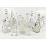 Ten assorted glass decanters and ewers to include bulbous examples, together with further glassware.