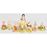 ROYAL DOULTON; a group, 'Snow White and the Seven Dwarfs', each with printed marks to base, height