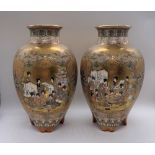 A pair of Japanese Meiji period Satsuma porcelain vases decorated with figures within a textured