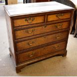 A Georgian oak and mahogany crossbanded chest of two over three drawers, raised on bracket feet,