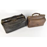 Two early 20th century Gladstone bags, the smaller initialled 'K', the larger with medical tools and