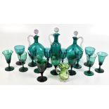 A group of Victorian green glass including two decanters with stoppers, wine glasses, etc.Additional