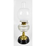 An oil lamp with opaque glass shade, clear chimney and reservoir on brass foot with relief floral