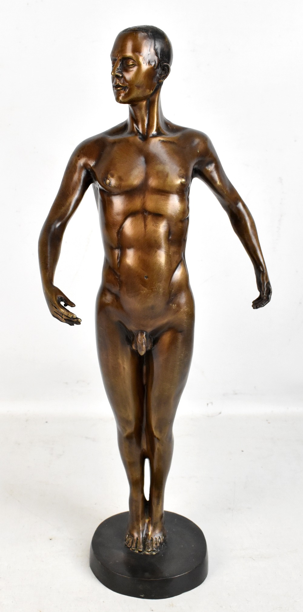 A mid-20th century bronzed sculpture of a nude male raised on circular plinth base, height 52cm,