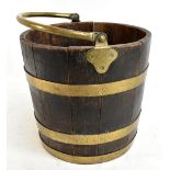 An oak brass bound coopered log bin with swing loop handle, height excluding handle 34cm, diameter