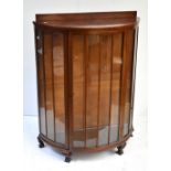 An early 20th century mahogany demilune display cabinet with single glazed door, height 121cm.